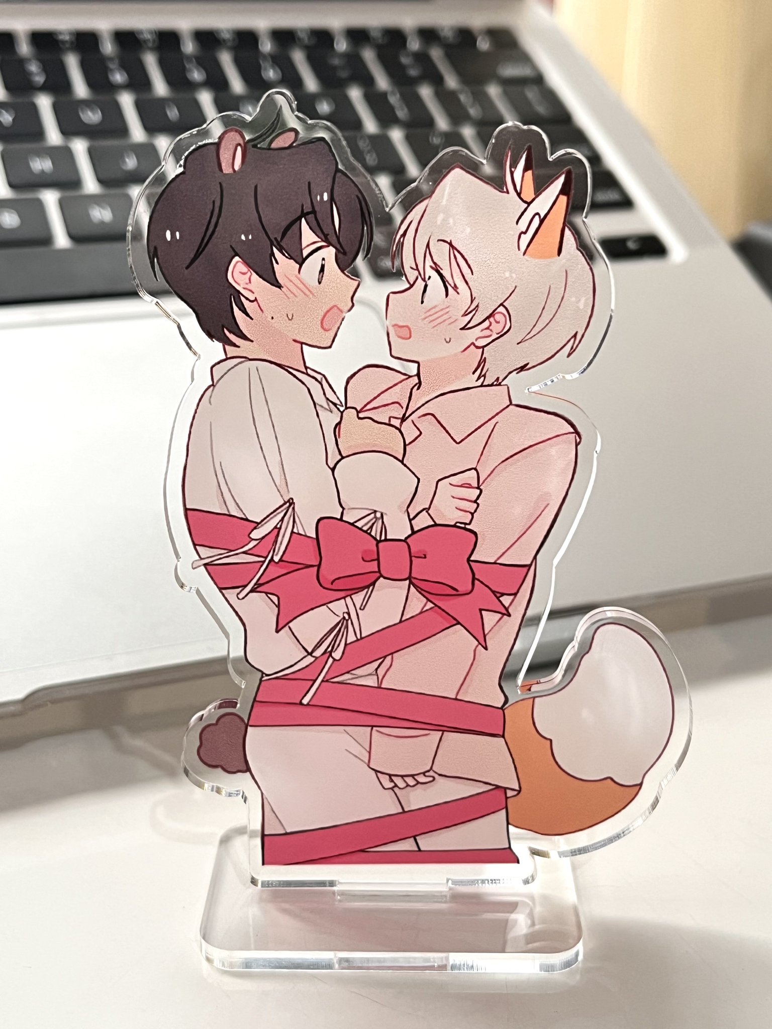 Statuette of a uppyboy and a catboy lied together